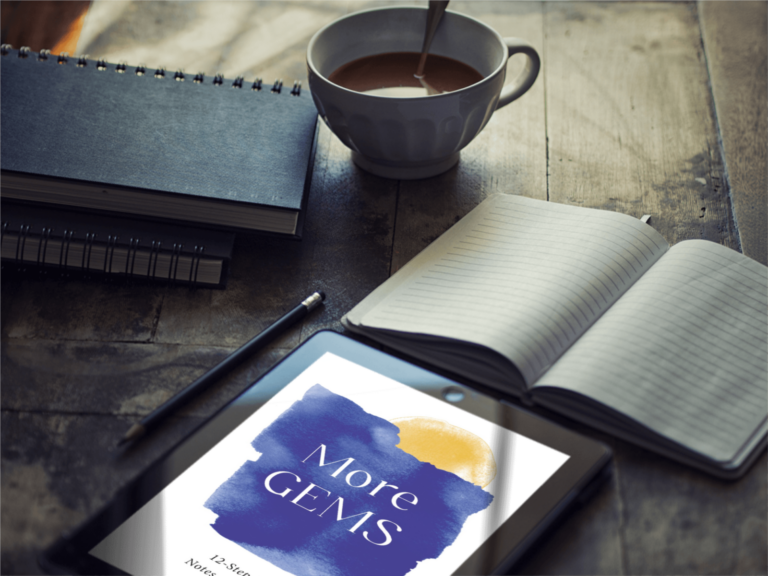 more gems displayed on tablet computer on table with an open notebook