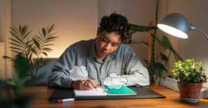 man writing at desk two way prayer thought bubbles