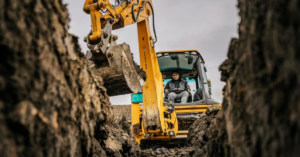 man digging foundations with excavator