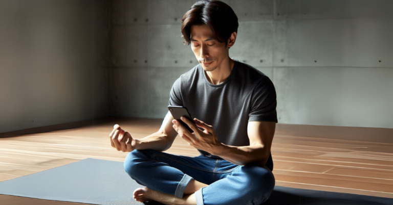 man distracted from his meditation by his cellphone