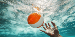 beach ball slipping out of hands under water