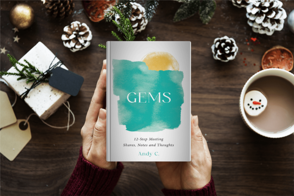 hands holding GEMS book in holiday scene