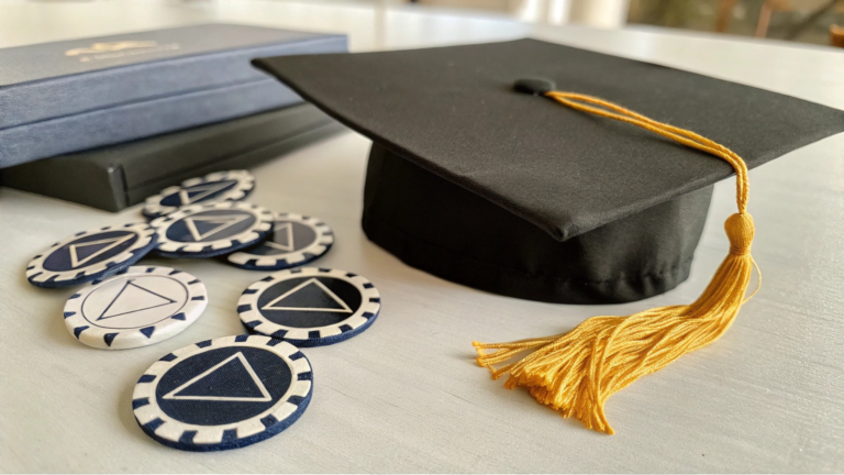 graduation cap and sobriety chips